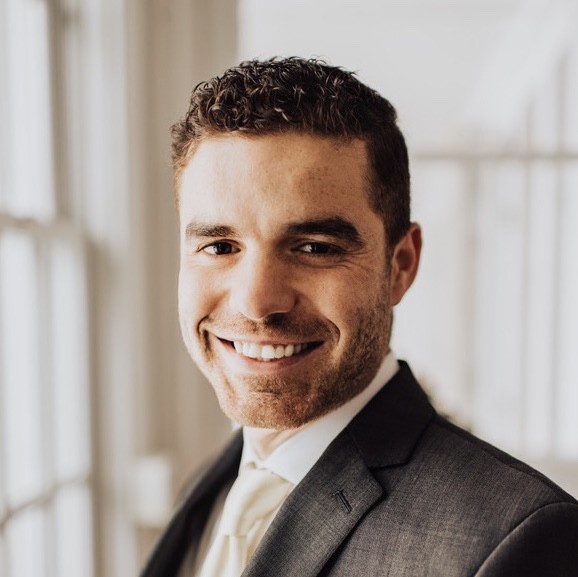 A color photo of a man smiling for a photo